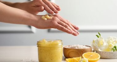 Woman,Applying,Body,Scrub,On,Hand,At,Wooden,Table,,Closeup