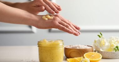 Woman,Applying,Body,Scrub,On,Hand,At,Wooden,Table,,Closeup